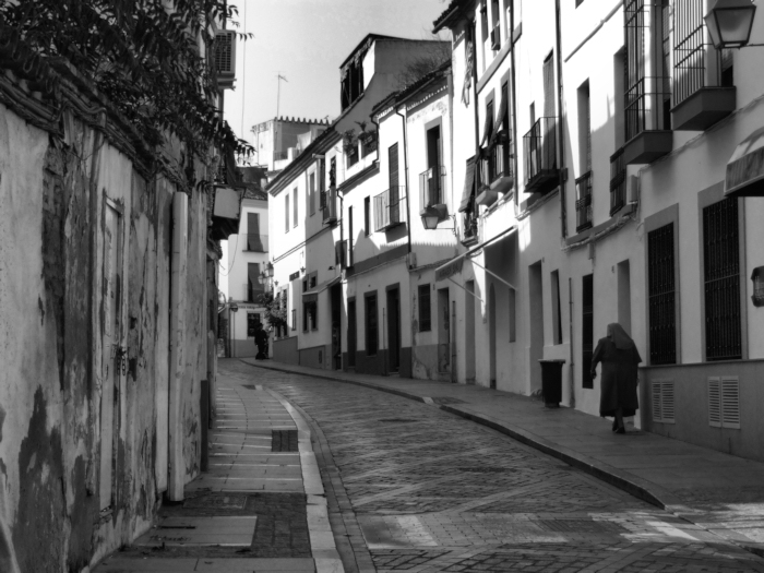 A Nun walking through a Spanish Street